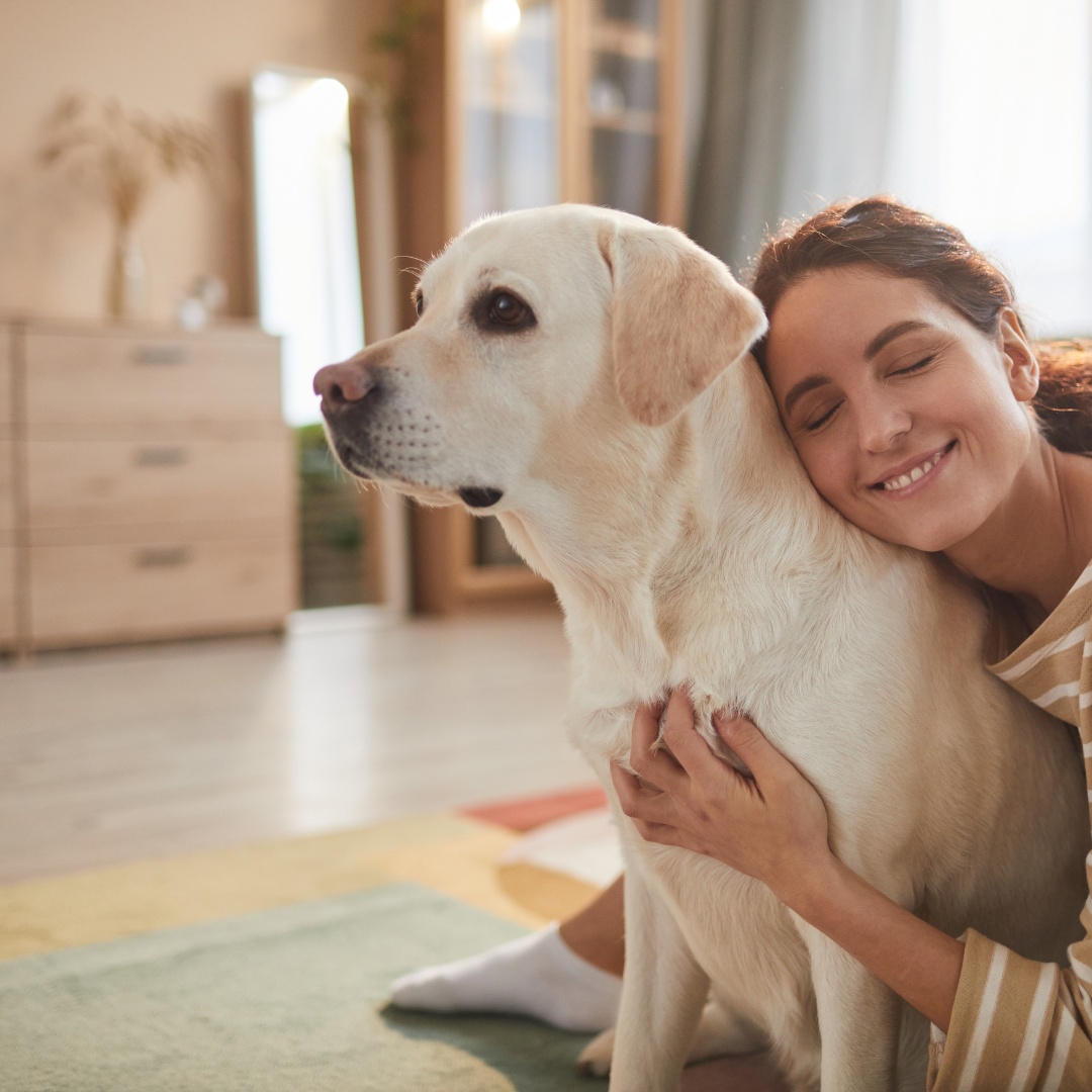 a woman is gently petting his dog